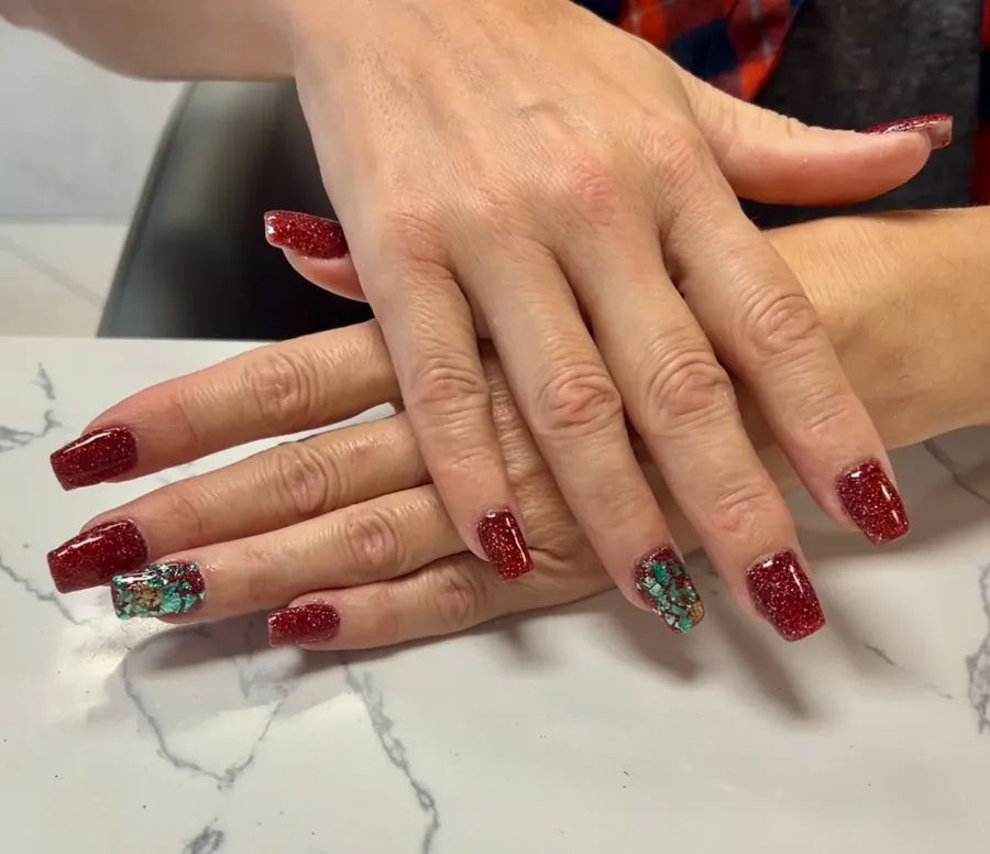 Red glitter nails with green and gold foil accent nails